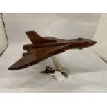 A LARGE WOODEN VULCAN BOMBER ON CHROME STAND