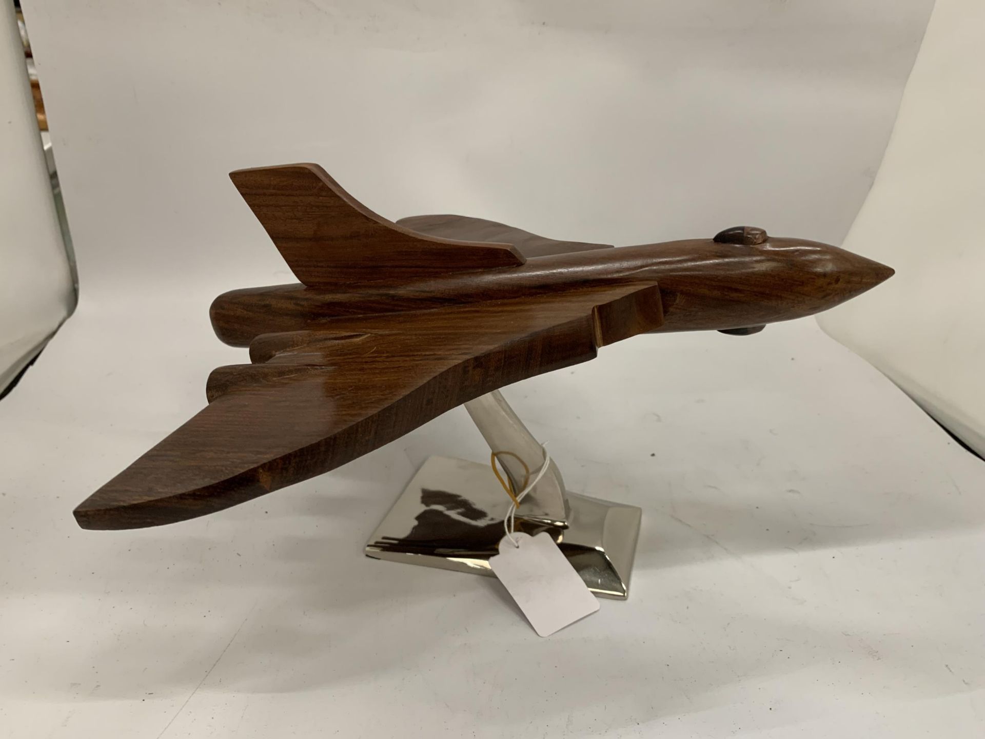 A LARGE WOODEN VULCAN BOMBER ON CHROME STAND