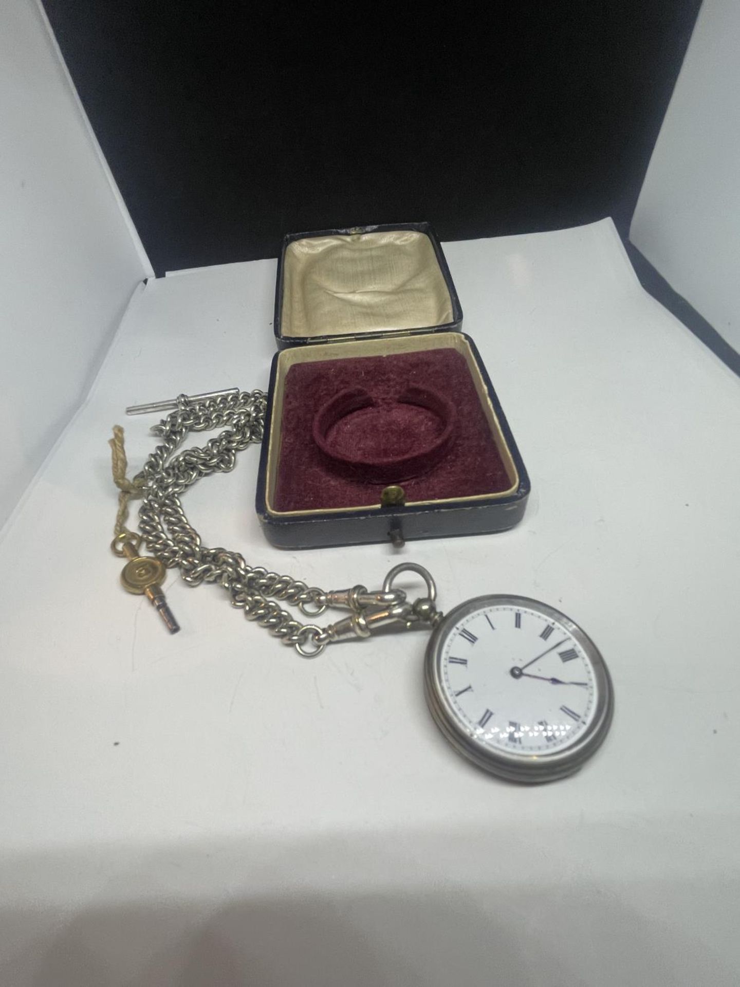 A SILVER POCKET WATCH WITH ALBERT CHAIN AND KEY IN A PRESENTATION BOX