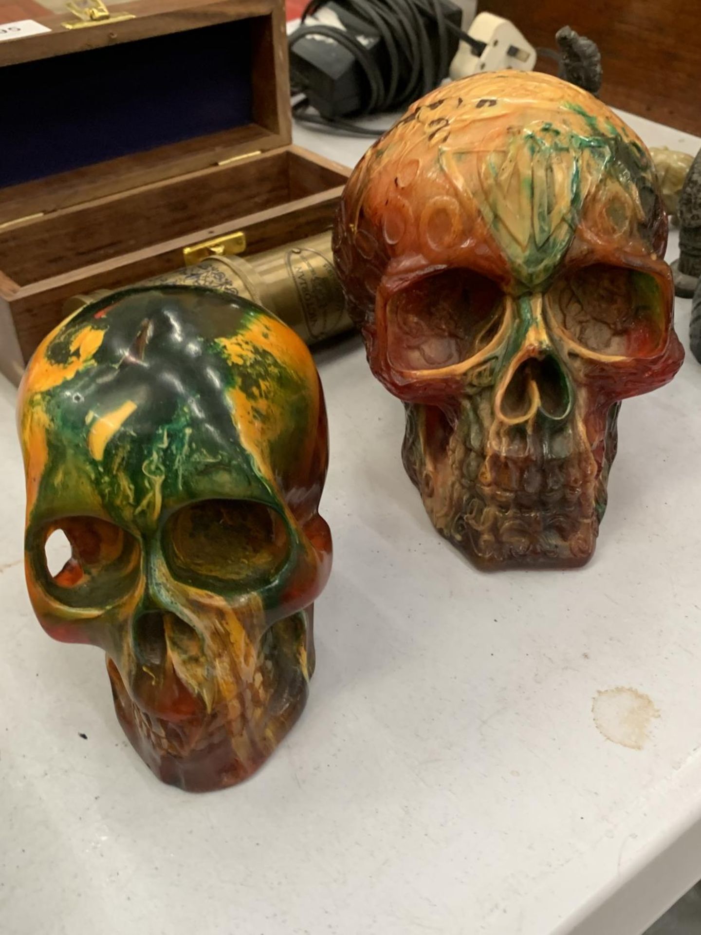 TWO RESIN SKULLS HEIGHTS 10CM AND 12CM