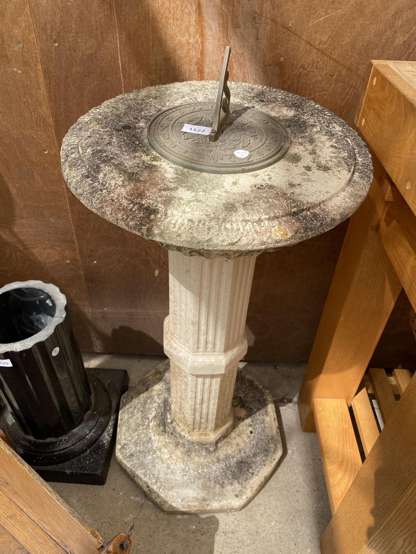 A RECONSTITUTED STONE SUNDIAL WITH BRASS GNOMAN TOP