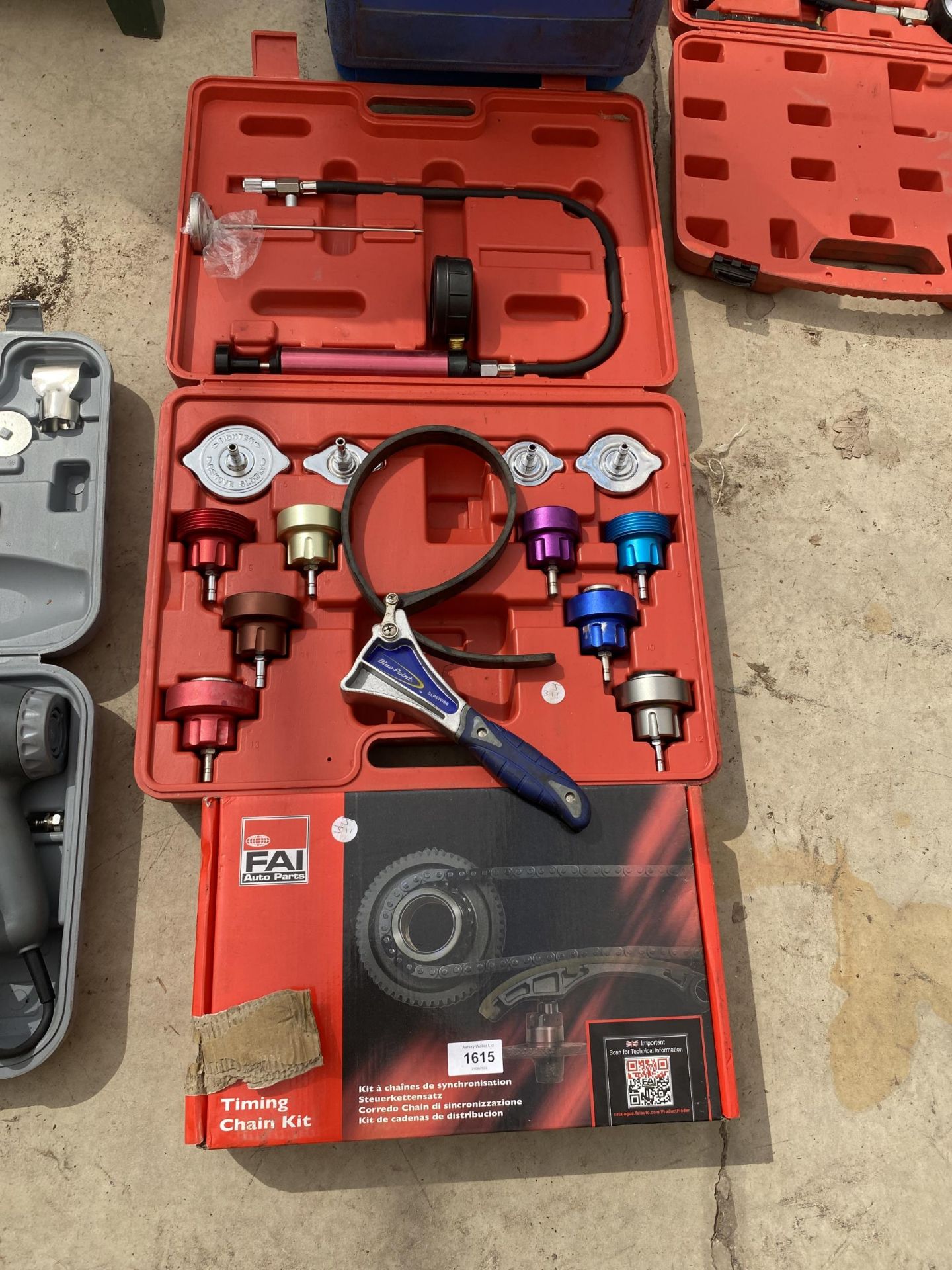 A CASED COLLING SYSTEM PRESSURE TESTER AND AN FAI AUTO PARTS TIMING CHAIN KIT