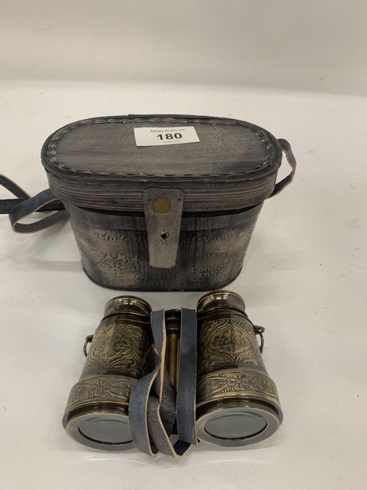 A PAIR OF BRASS BINOCULARS IN A ROYAL NAVY CASE