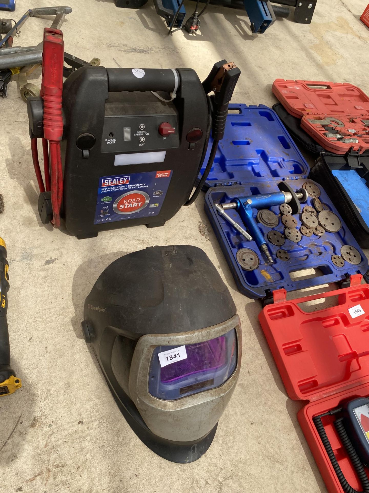 A SEALEY BATTERY JUMP STARTER AND A WELDING MASK