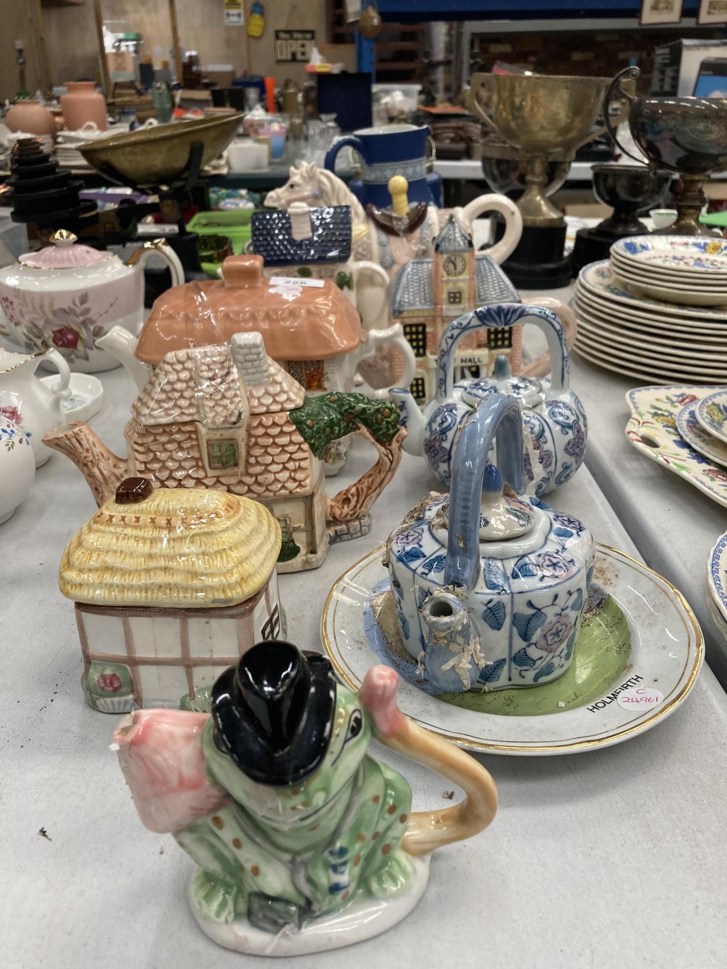 A COLLECTION OF NOVELTY CERAMIC TEAPOTS TO INCLUDE FROG AND PONY EXAMPLES