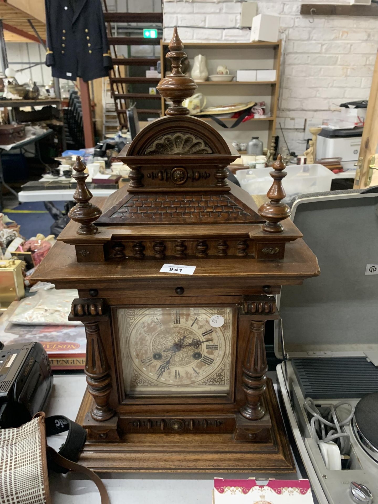 A LARGE MAHOGANY CASED MANTLE CLOCK WITH COLUMN CARVING, IN NEED OF RESTORATION