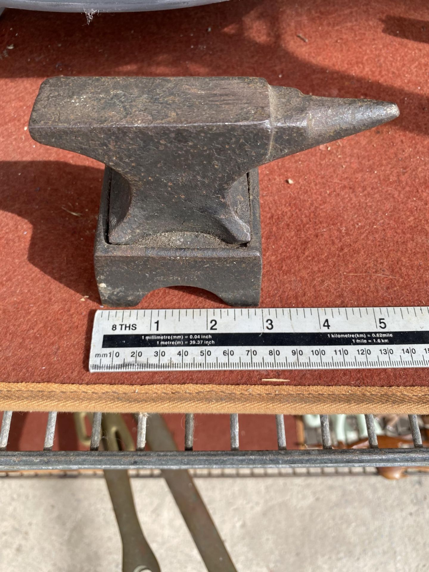 A MINIATURE CAST IRON SAMPLE ANVIL WITH STAND