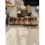 AN ASSORTMENT OF VINTAGE CAST IRON WEIGHTS TO INCLUDE A 56LB, TWO 14LB AND THREE 7LB