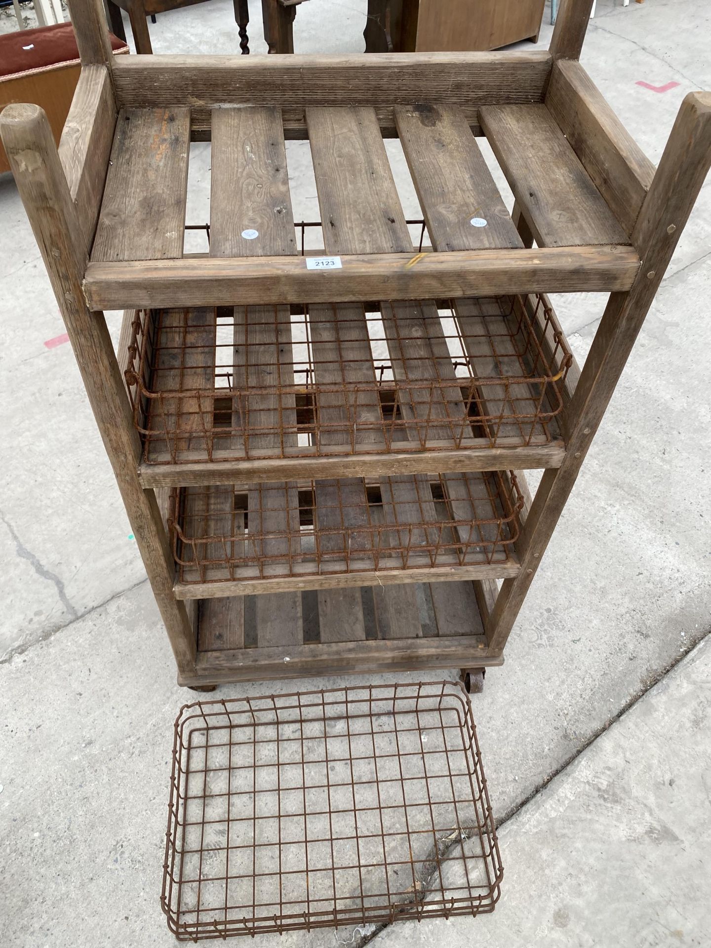 A TALL RUSTIC FOUR TIER WOODEN FOUR WHEELED STAND WITH WIRE BASKET TRAYS - Image 5 of 6