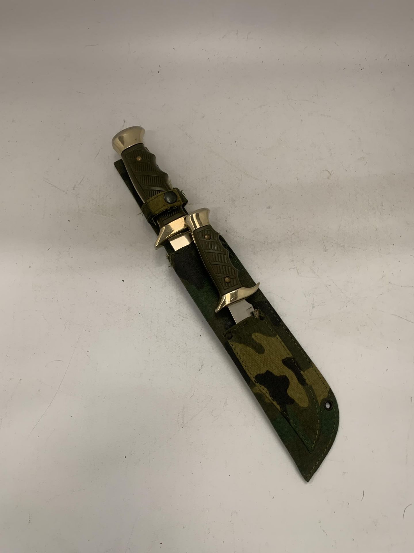 TWO HUNTING KNIVES IN A CAMOFLAGUE SHEATH