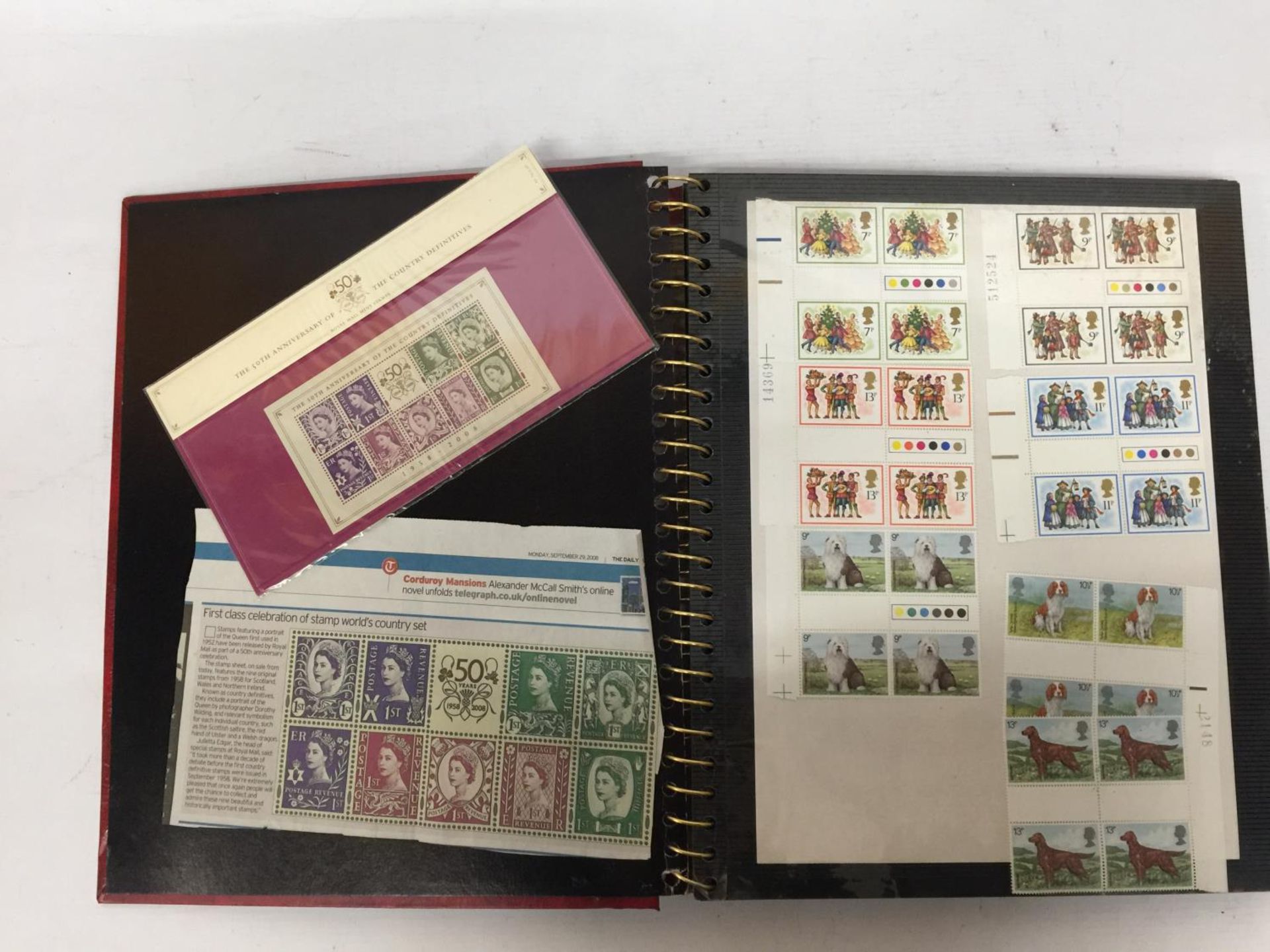 A STAMP ALBUM CONTAINING A LARGE QUANTITY OF BRITISH MINT STAMPS