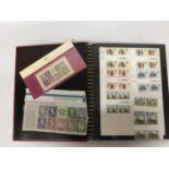 A STAMP ALBUM CONTAINING A LARGE QUANTITY OF BRITISH MINT STAMPS