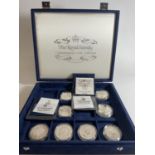 PRESENTATION CASE HOUSING ROYAL FAMILY COMMEMORATIVE COINS TO INCLUDE : PITCAIRN, FALKLANDS,