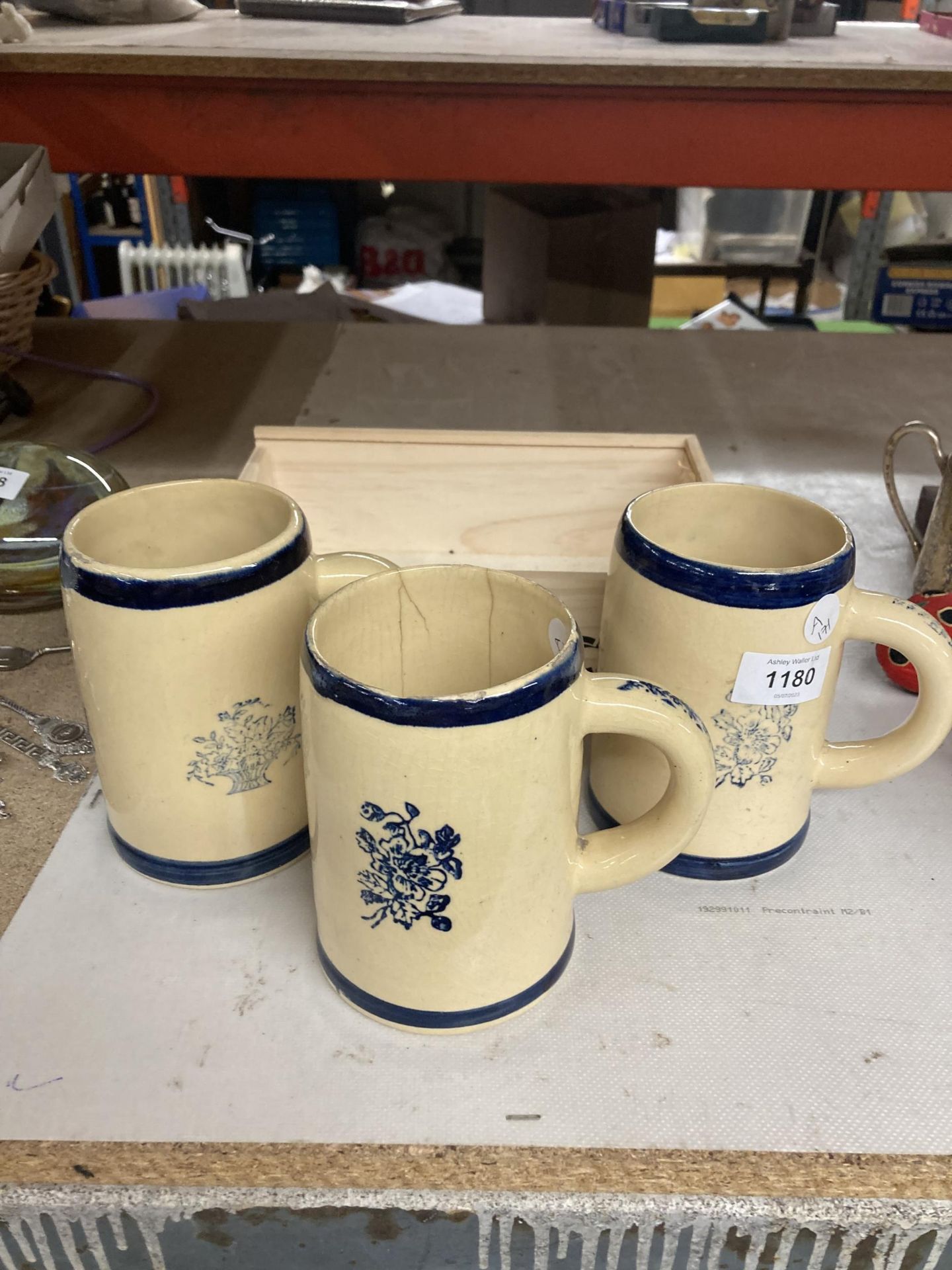 A GROUP OF THREE VINTAGE TANKARDS AND SMALL WOODEN CRATE