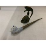 A VINTAGE TOBACCO SMOKING PIPE WITH CERAMIC CAT HEAD PLUS A BRONZE STYLE ROMAN HELMET BELL