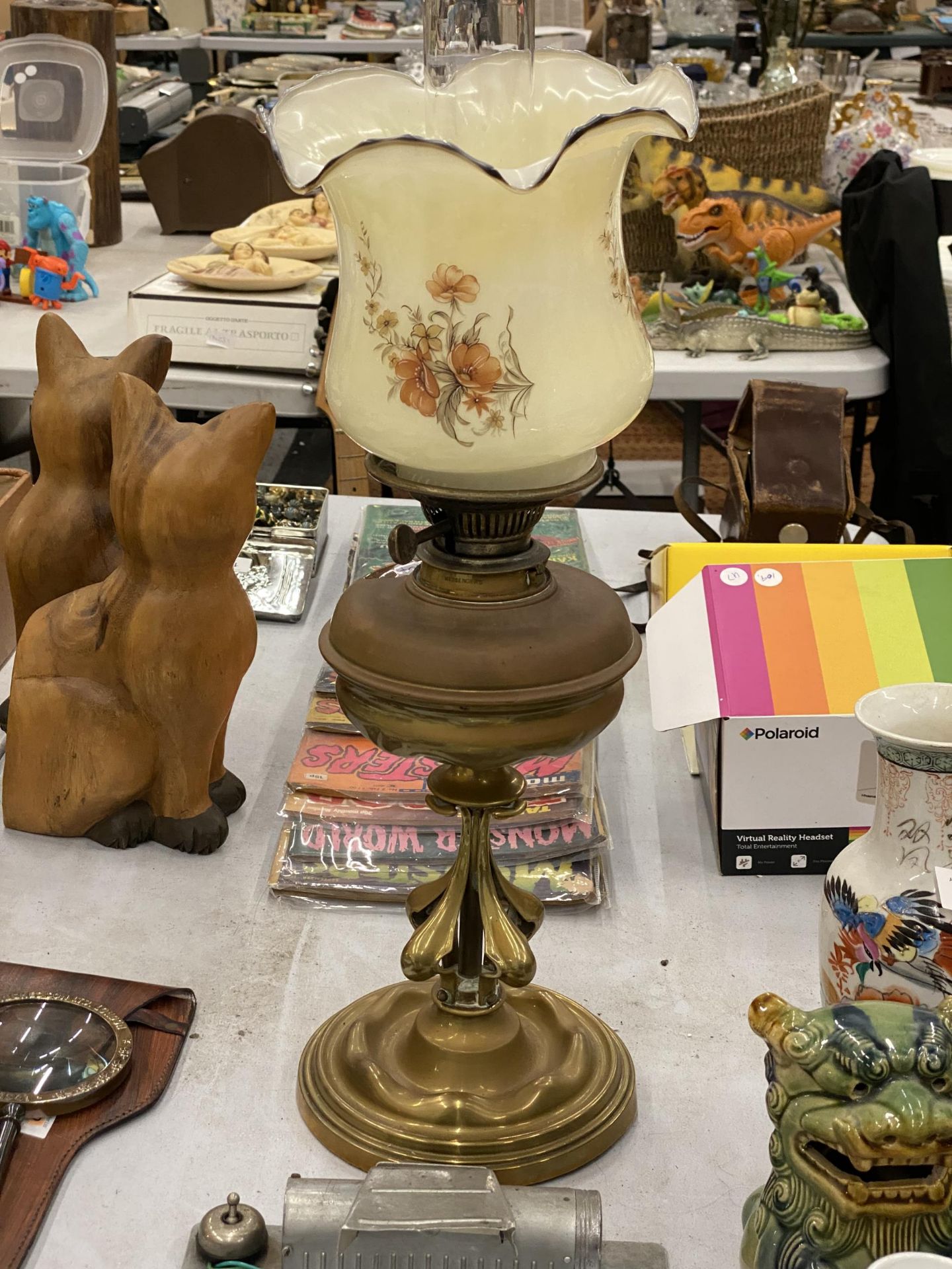 AN ARTS AND CRAFTS STYLE OIL LAMP WITH GLASS FLORAL SHADE