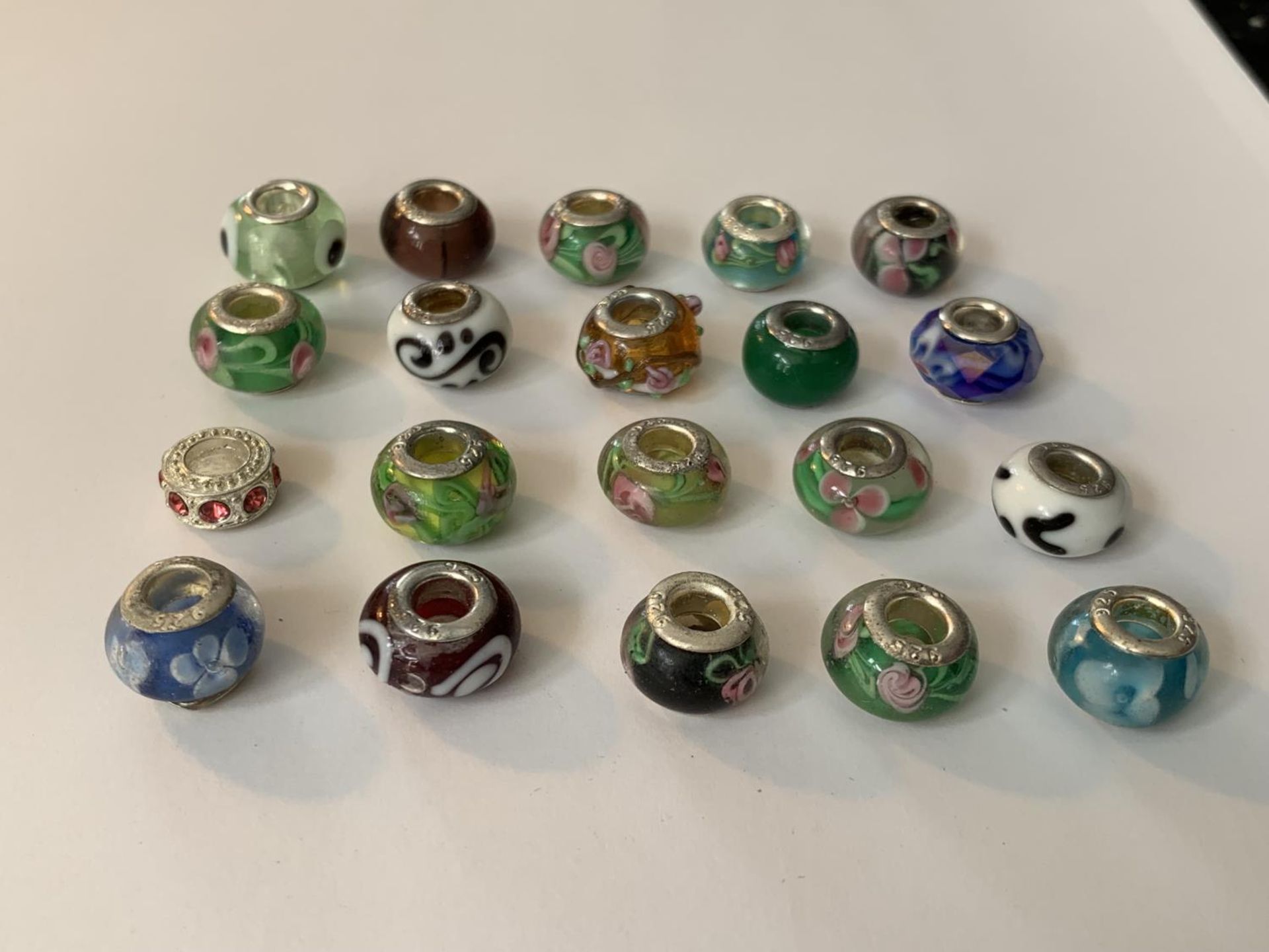 TWENTY SILVER RIMMED MURANO BEADS