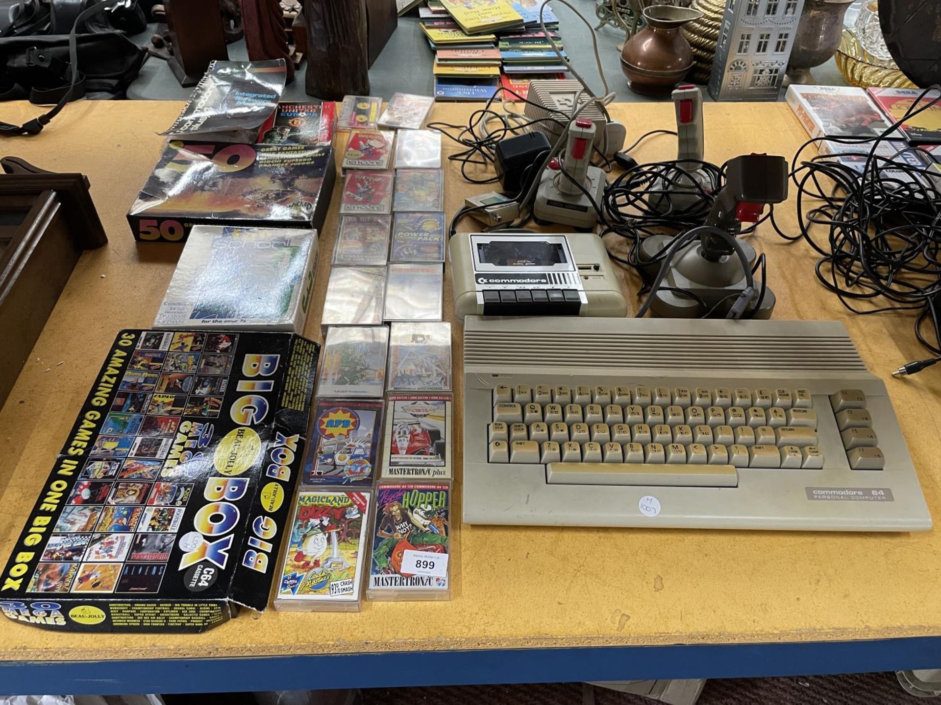 A VINTAGE COMMODORE 64 GAMES SYSTEM WITH JOYSTICKS, A DATASSETTE PLUS A QUANTITY OF GAMES TO INCLUDE