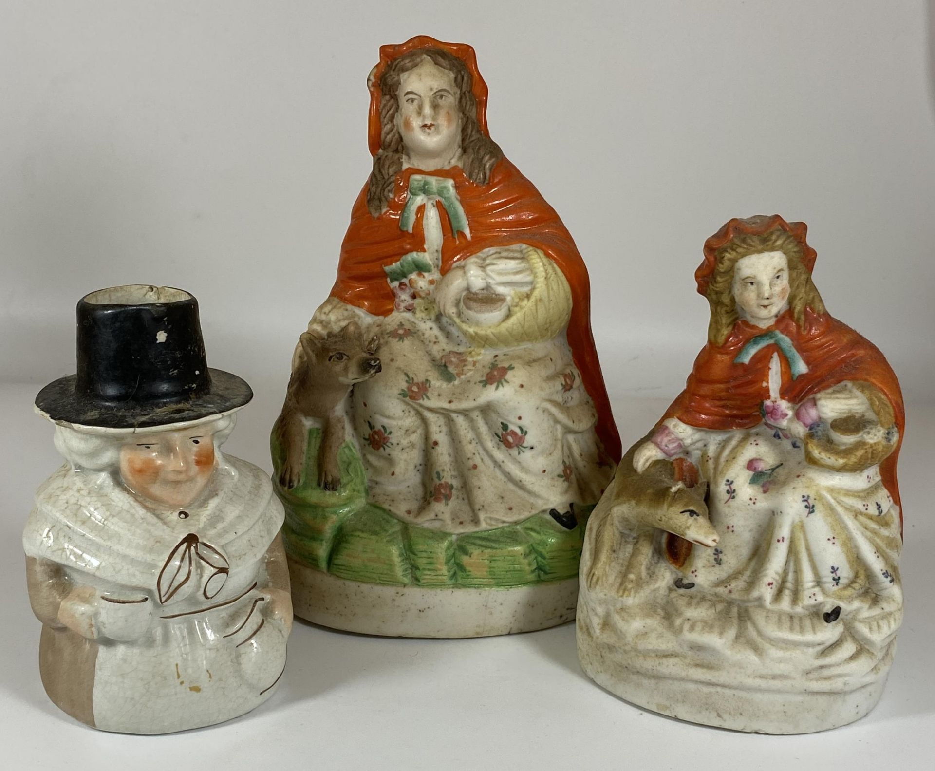 A GROUP OF THREE STAFFORDSHIRE POTTERY FIGURES, LITTLE RED RIDING HOOD ETC