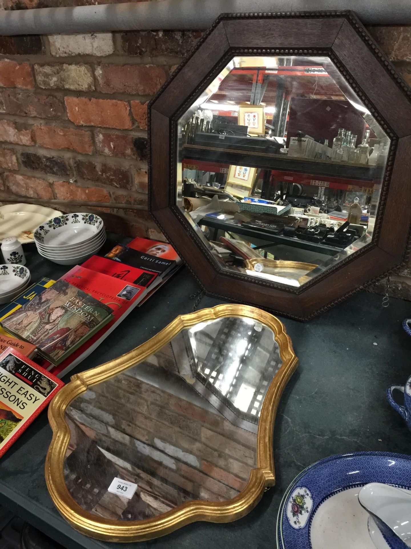 A VINTAGE MAHOGANY FRAMED OCTAGONAL MIRROR WITH BEVELLED GLASS PLUS A SHIELD SHAPED GILT FRAMED