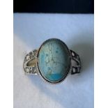 A SILVER RING WITH AN OVAL STONE SIZE R/S IN A PRESENTATION BOX