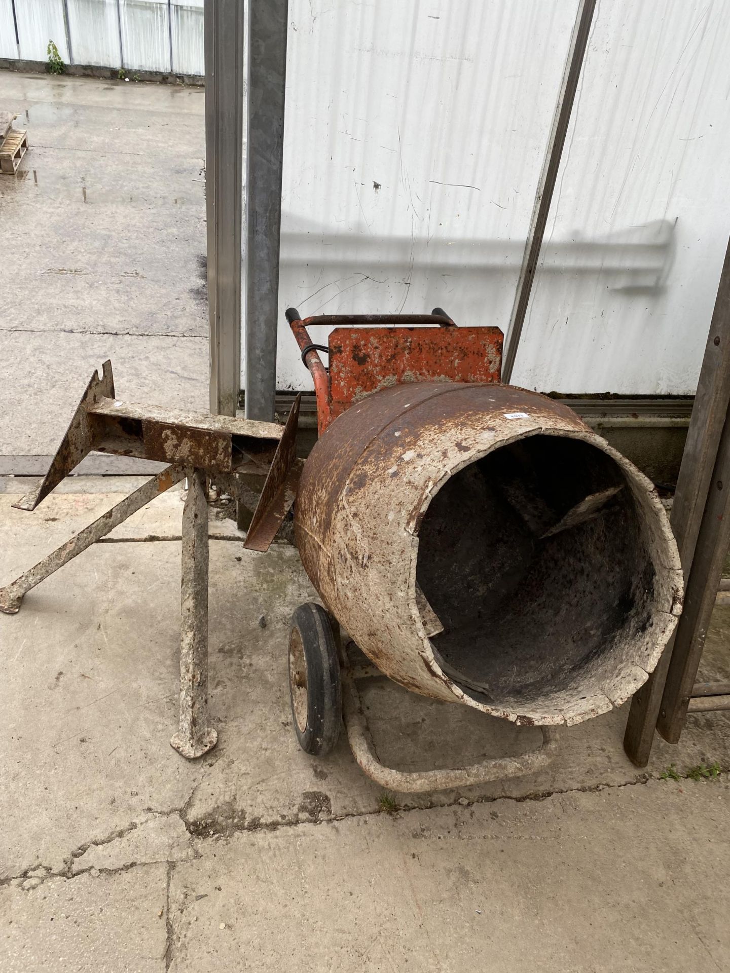 AN ELECTRIC CEMENT MIXER COMPLETE WITH STAND