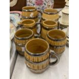 A COLLECTION OF WADE BARREL SHAPED TANKARDS PLUS A JUG