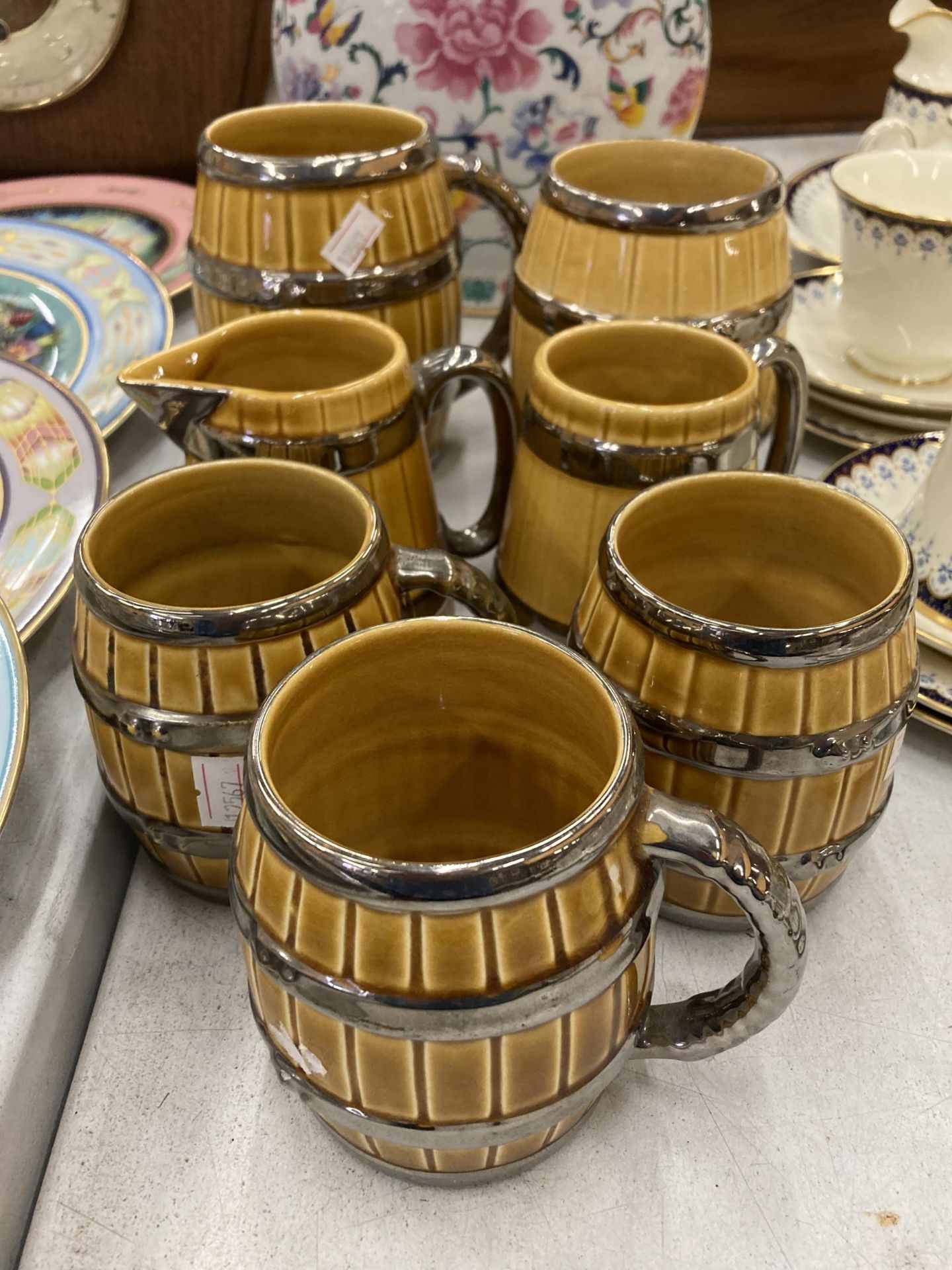 A COLLECTION OF WADE BARREL SHAPED TANKARDS PLUS A JUG