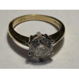 AN 18 CARAT GOLD RING WITH A 1.5 CARAT ROUND CUT DIAMOND SIZE J/K