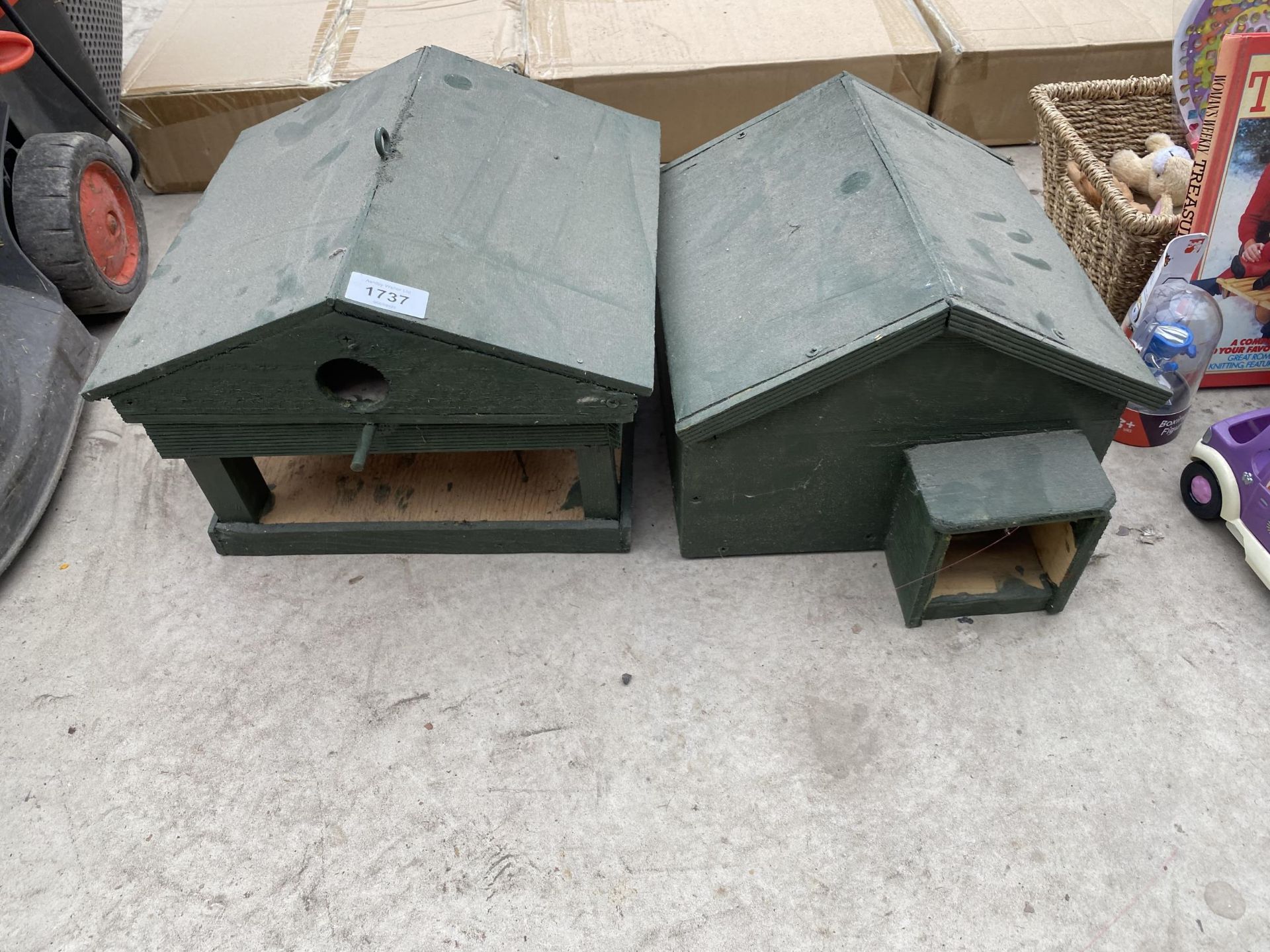 A WOODEN BIRD HOUSE AND A WOODEN HEDGEHOG HOUSE