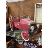 A VINTAGE CHILDS RIDE ALONG PEDAL FIRE TRUCK