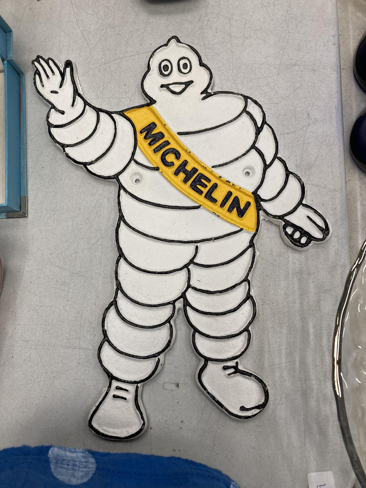 A CAST MICHELIN MAN SIGN