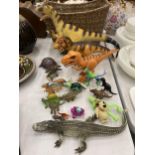A COLLECTION OF DINOSAURS, ETC IN A BASKET