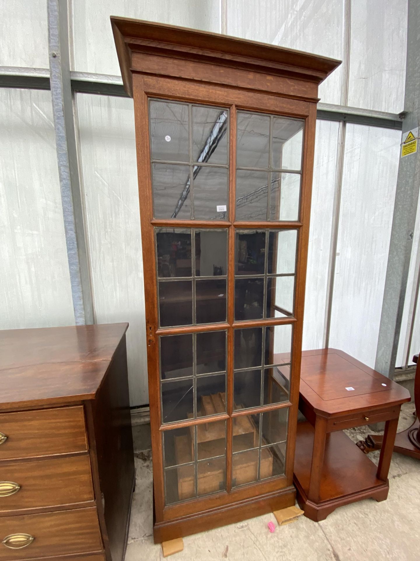 AN EARLY 20TH CENTURY OAK GLAZED AND LEADED GUN CABINET WITH STEPPED INTERNAL SHELVES AND DRAWERS,