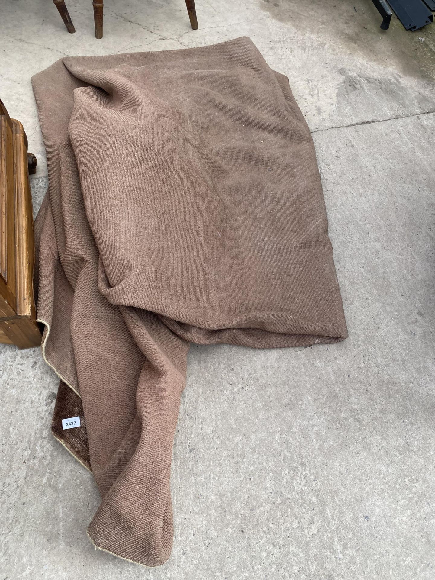 A LARGE MODERN BROWN RUG