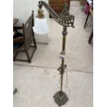 A CAST IRON AND BRASS READING LAMP ON CLAW FEET