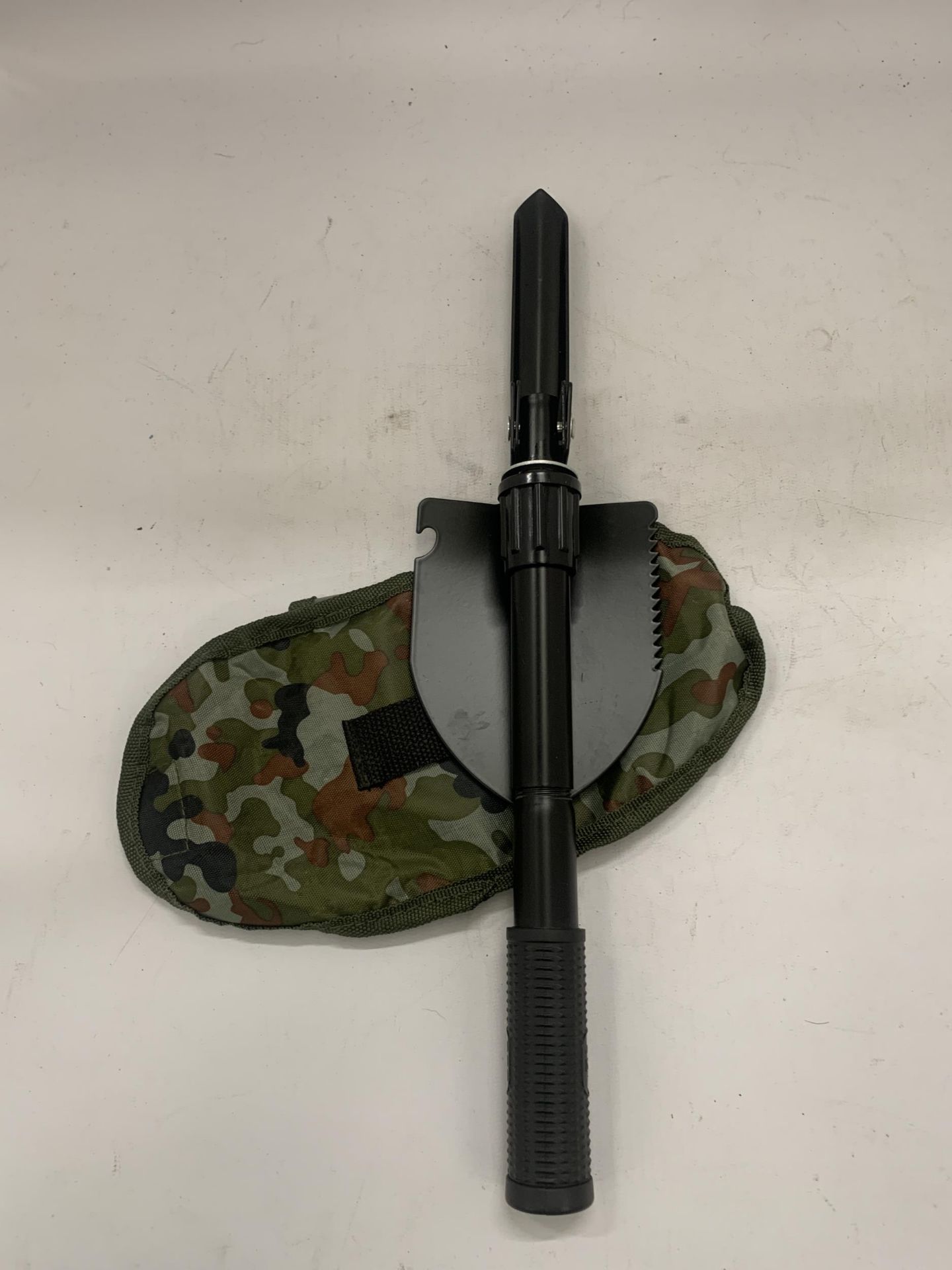 A MILITARY STYLE TRENCH SHOVEL IN A CASE