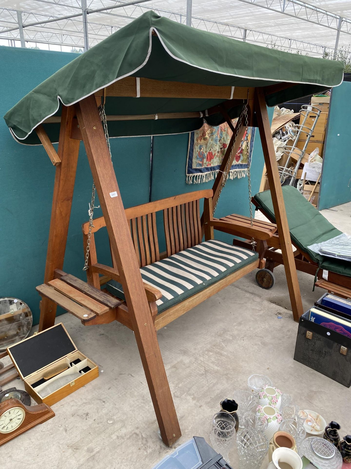 A TEAK GARDEN SWING SEAT WITH CANOPY TOP