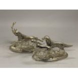 TWO WHITE METAL ORNAMENTS OF A STAG AND TWO HUNTING DOGS