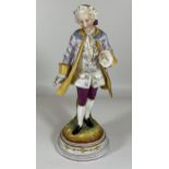 A CONTINENTAL HAND PAINTED PORCELAIN FIGURE OF A GENTLEMEN, HEIGHT 26CM