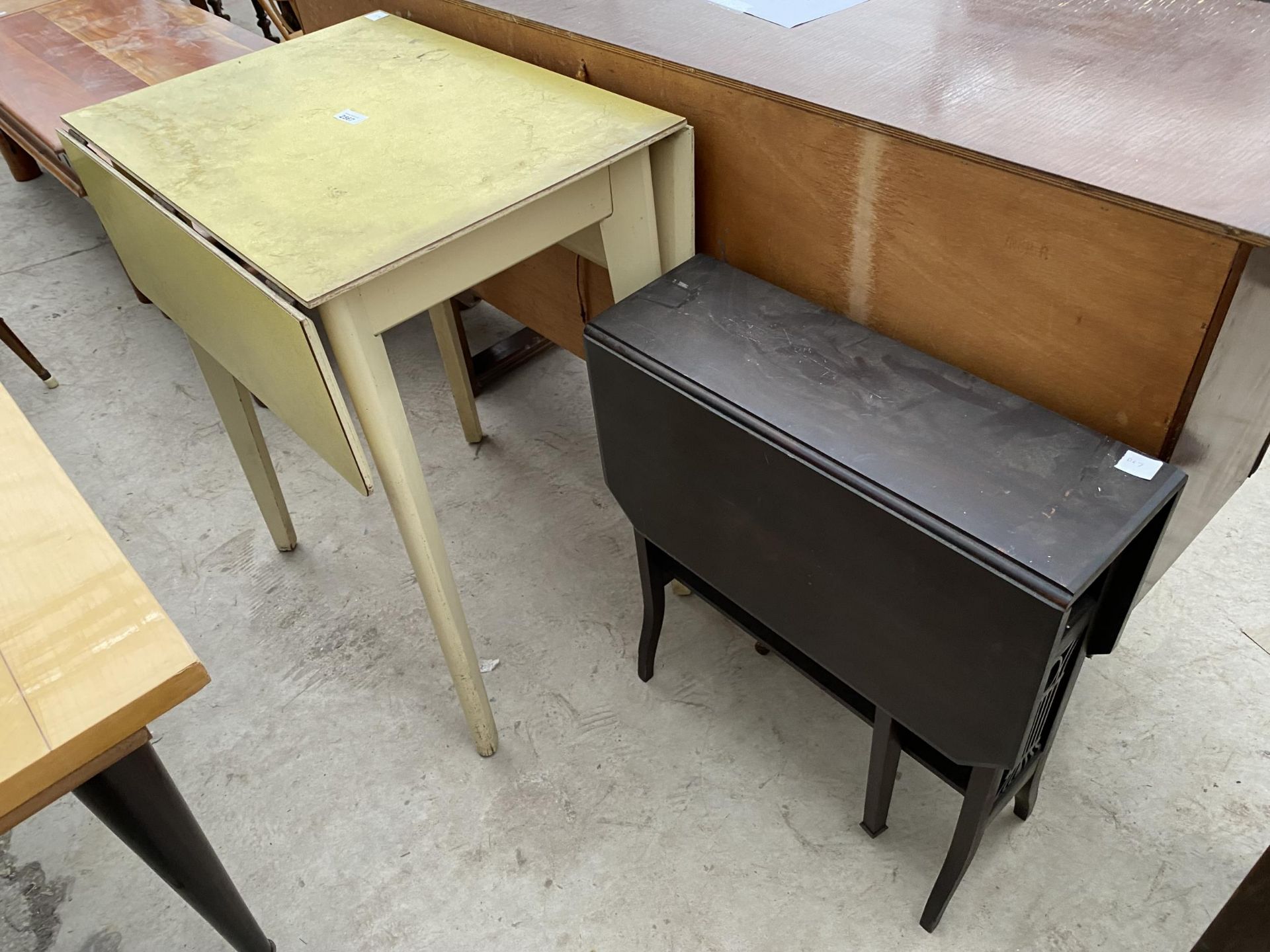 A 1950'S VIVID YELLOW DROP-LEAF AND EBONISED SUTHERLAND TABLE