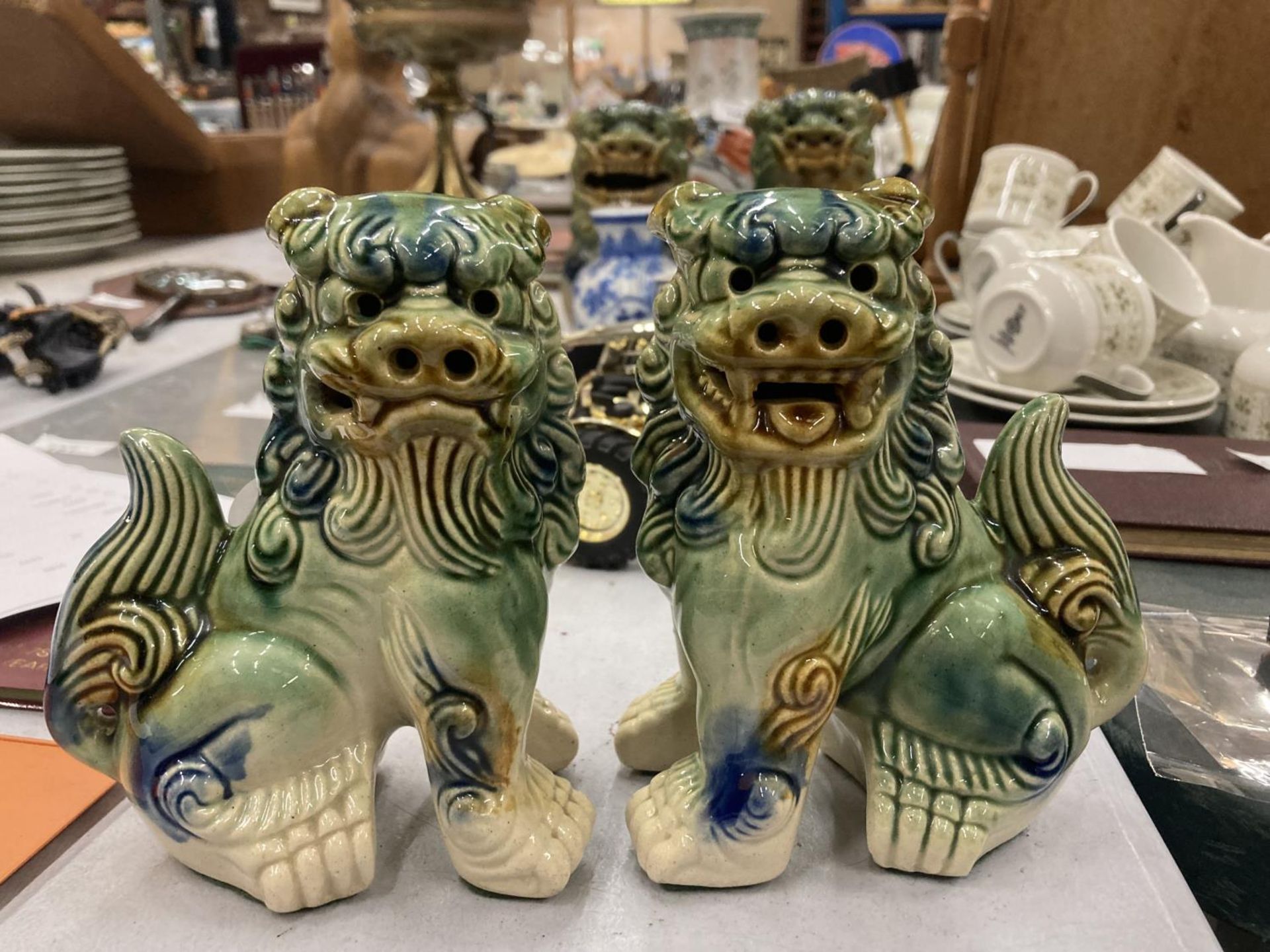 A PAIR OF ORIENTAL STYLE FOO DOGS HEIGHT 14CM