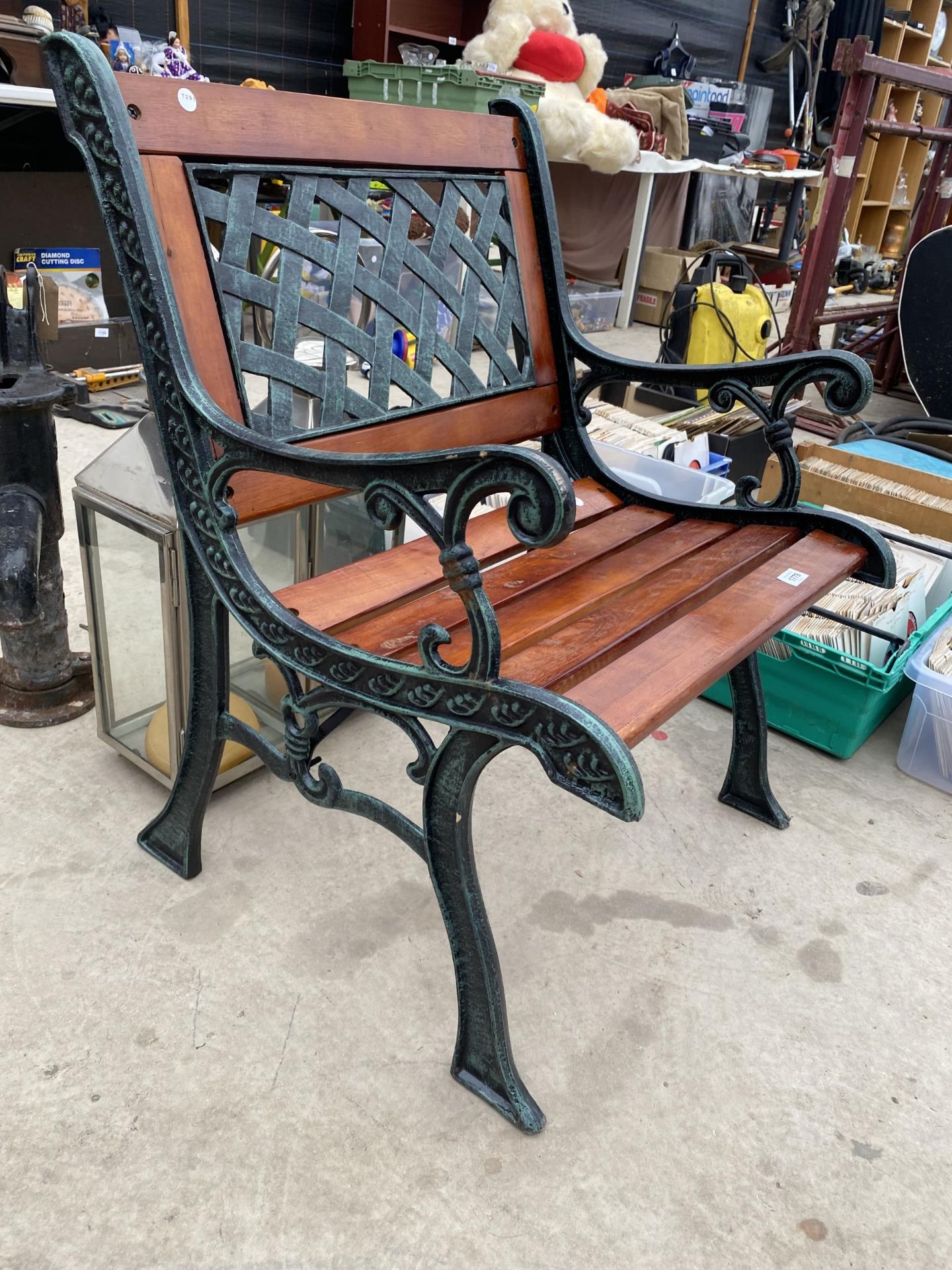 A WOODEN SLATTED GARDEN CHAIR WITH CAST ENDS AND A CAST BACK - Image 2 of 2