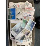 A BOX OF ASSORTED POSTCARDS