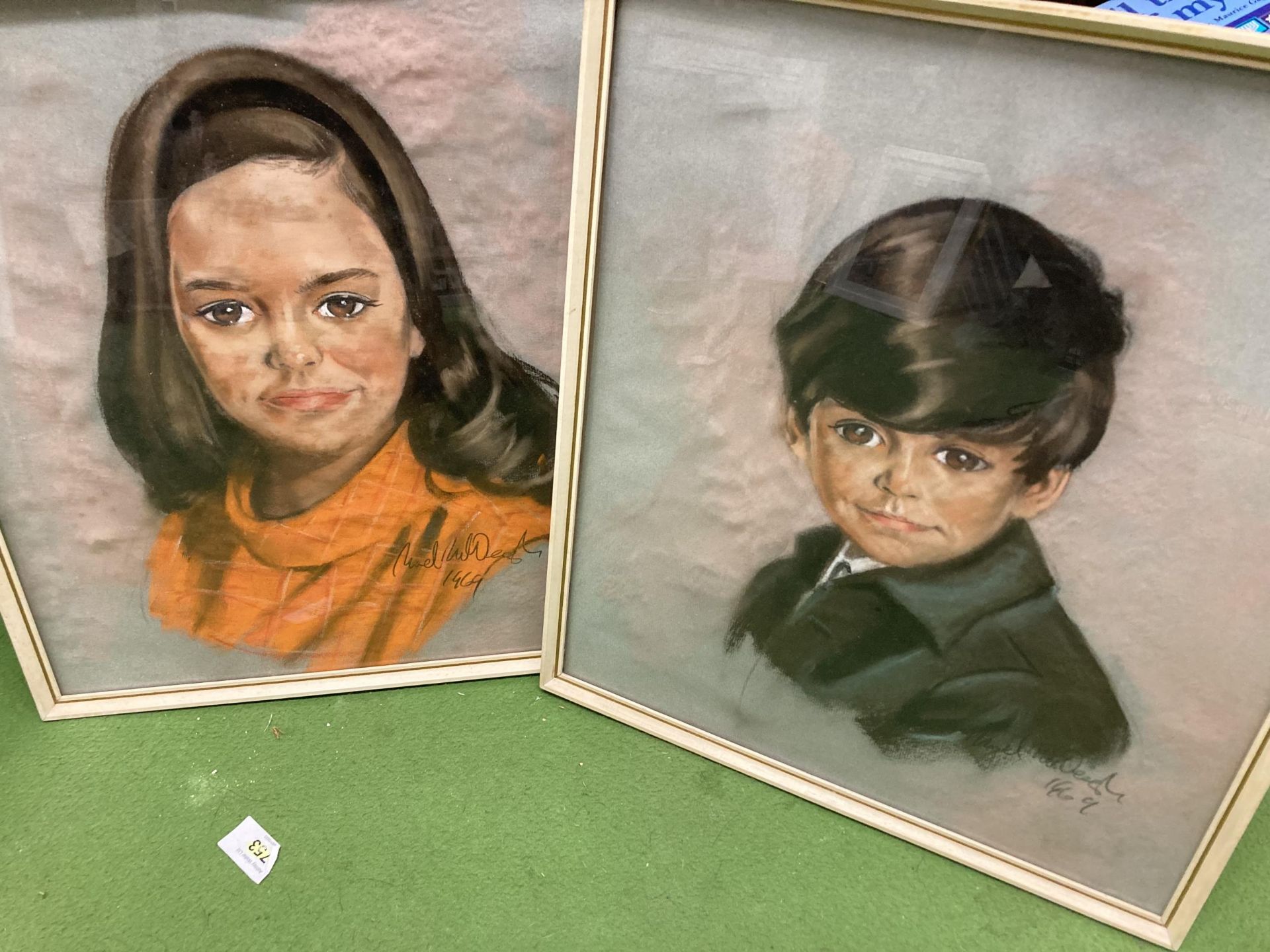 A PAIR OF FRAMED PASTELS OF A BOY AND GIRL, INDISTINCTLY SIGNED