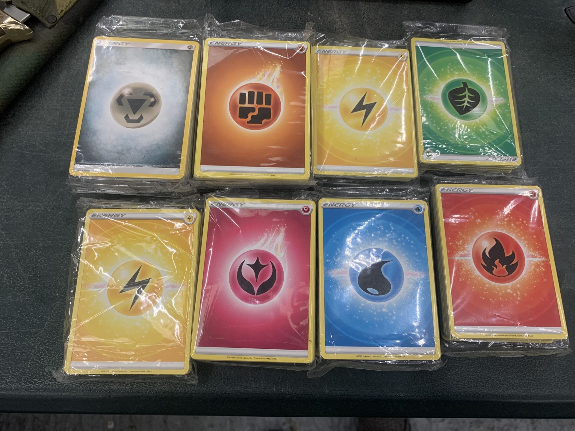 A COLLECTION OF 450+ POKEMON ENERGY CARDS, SEALED IN BAGS FROM ELITE TRAINER BOXES, ETC