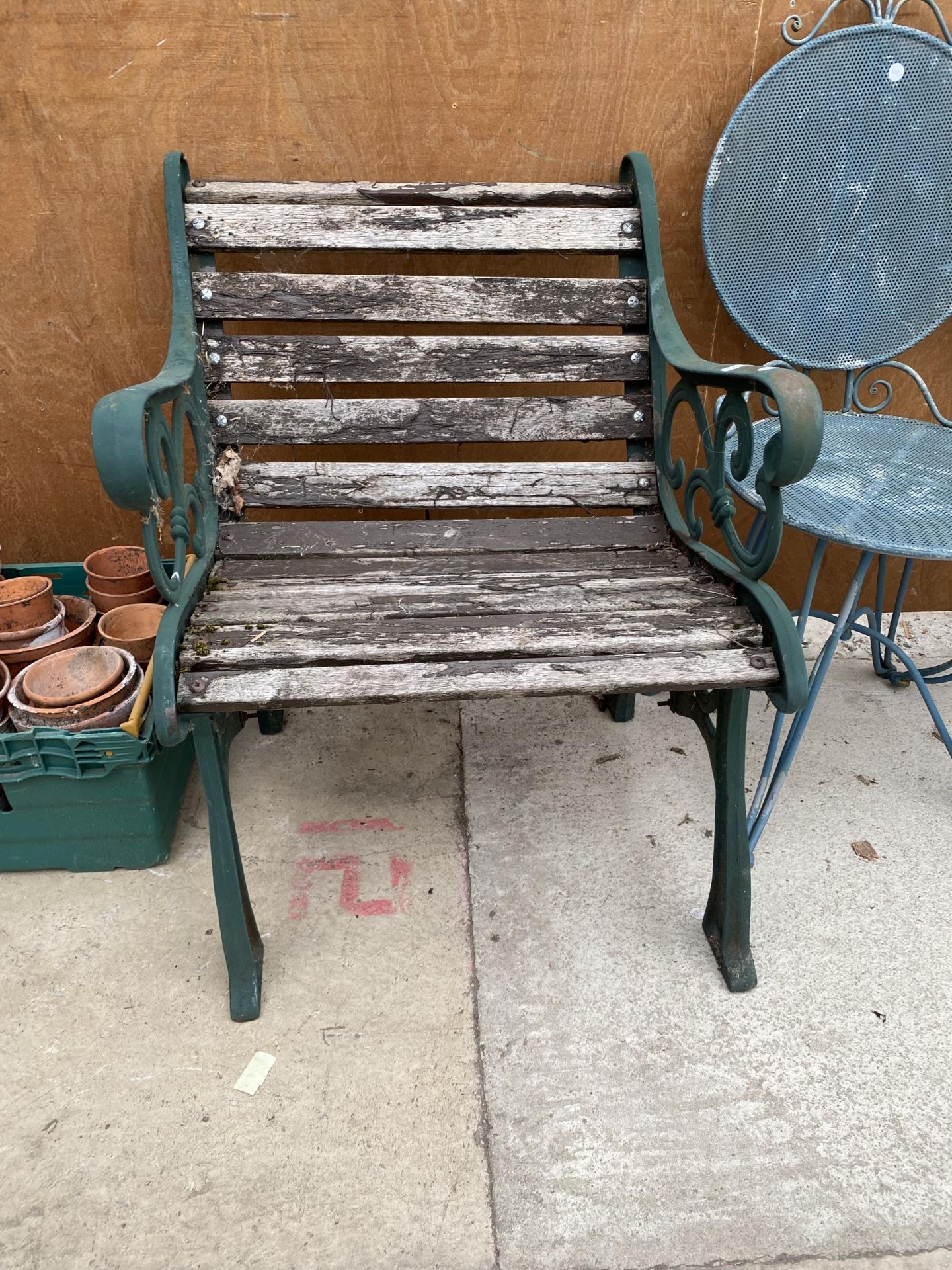 A WOODEN SLATTED GARDEN CHAIR WITH CAST ENDS - Image 2 of 2