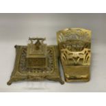 AN ART NOUVEAU STYLE BRASS INKWELL WITH LETTER RACK PLUS AN ORNATE BRASS INKWELL