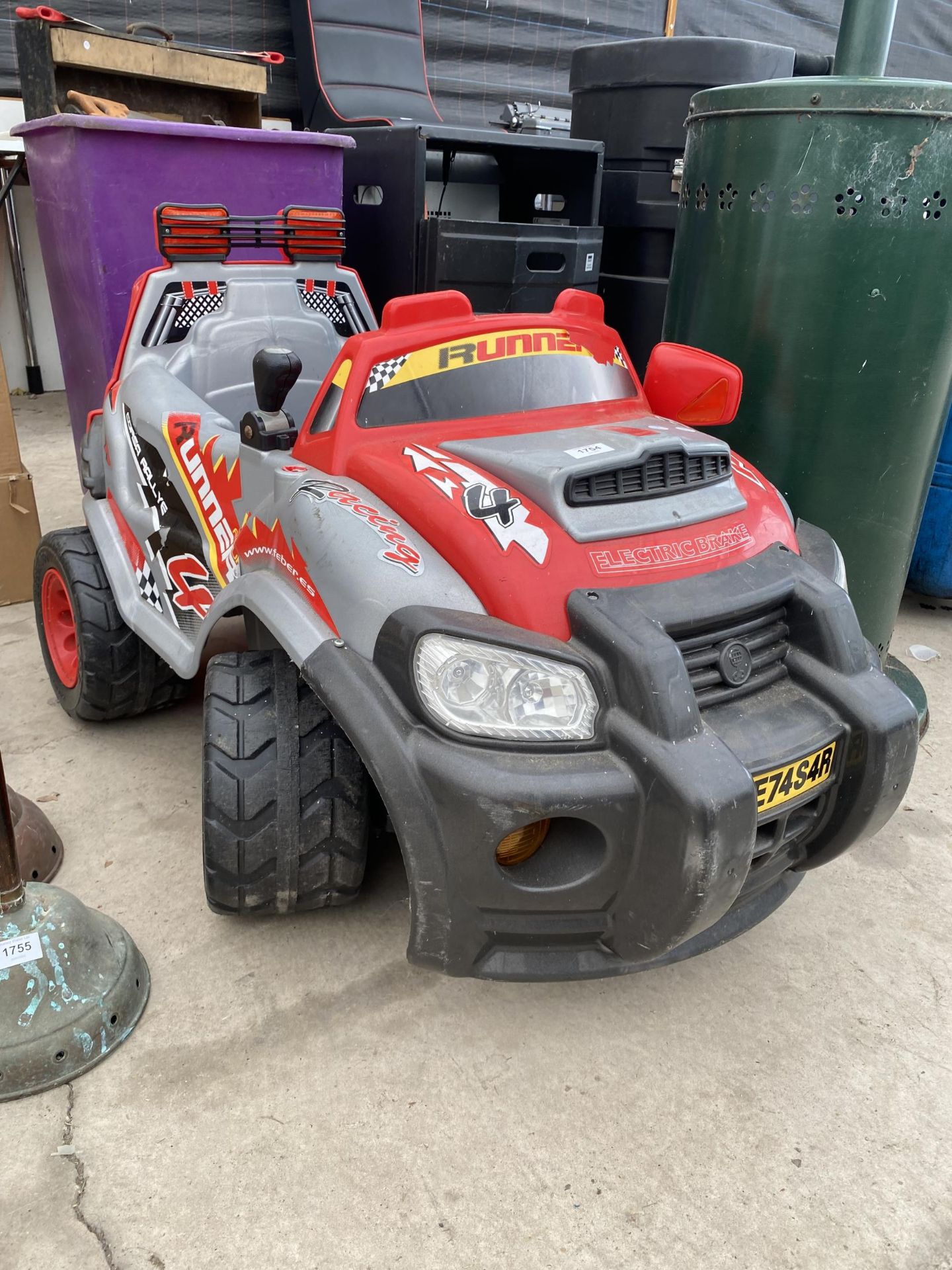 A CHILDS RIDE ALONG ELECTRIC BRAKE CAR COMPLETE WITH CHARGER IN THE OFFICE