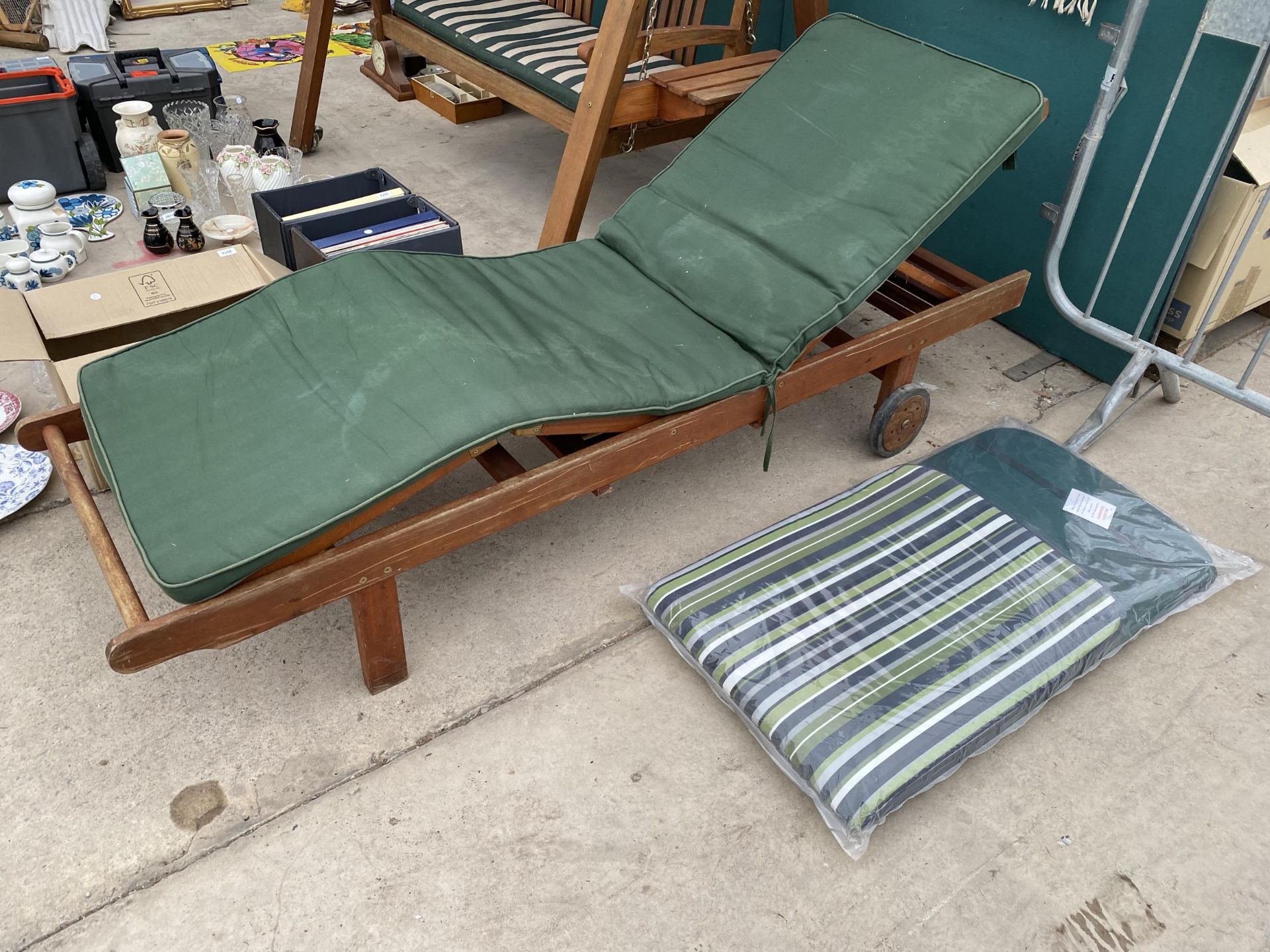 A TEAK GARDEN SUN LOUNGER WITH CUSHION